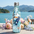Tropical Stainless Steel Bottle — 500ml on a table overlooking a lake
