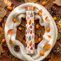Sowpeace Leaf Elixir Copper Bottle with a scarf on fall leaves