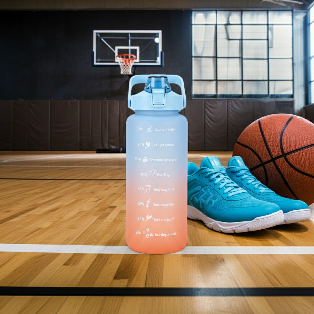 Aquatica HydroMark 2L Motivational Water Bottle — BPA-Free, Time-Marker Tracker, Straw Lid next to sneakers and a basketball 
