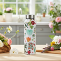 Petal and Plume Big Steel Bottle 750 mL in a kitchen decorated with flowers