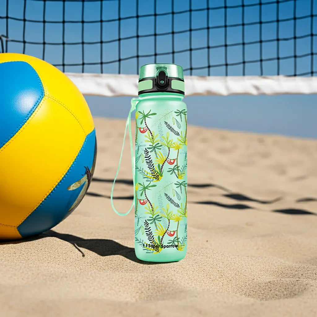 Super Sparrow Tritan Sports Water Bottle on a beach next to a blue and yellow volleyball