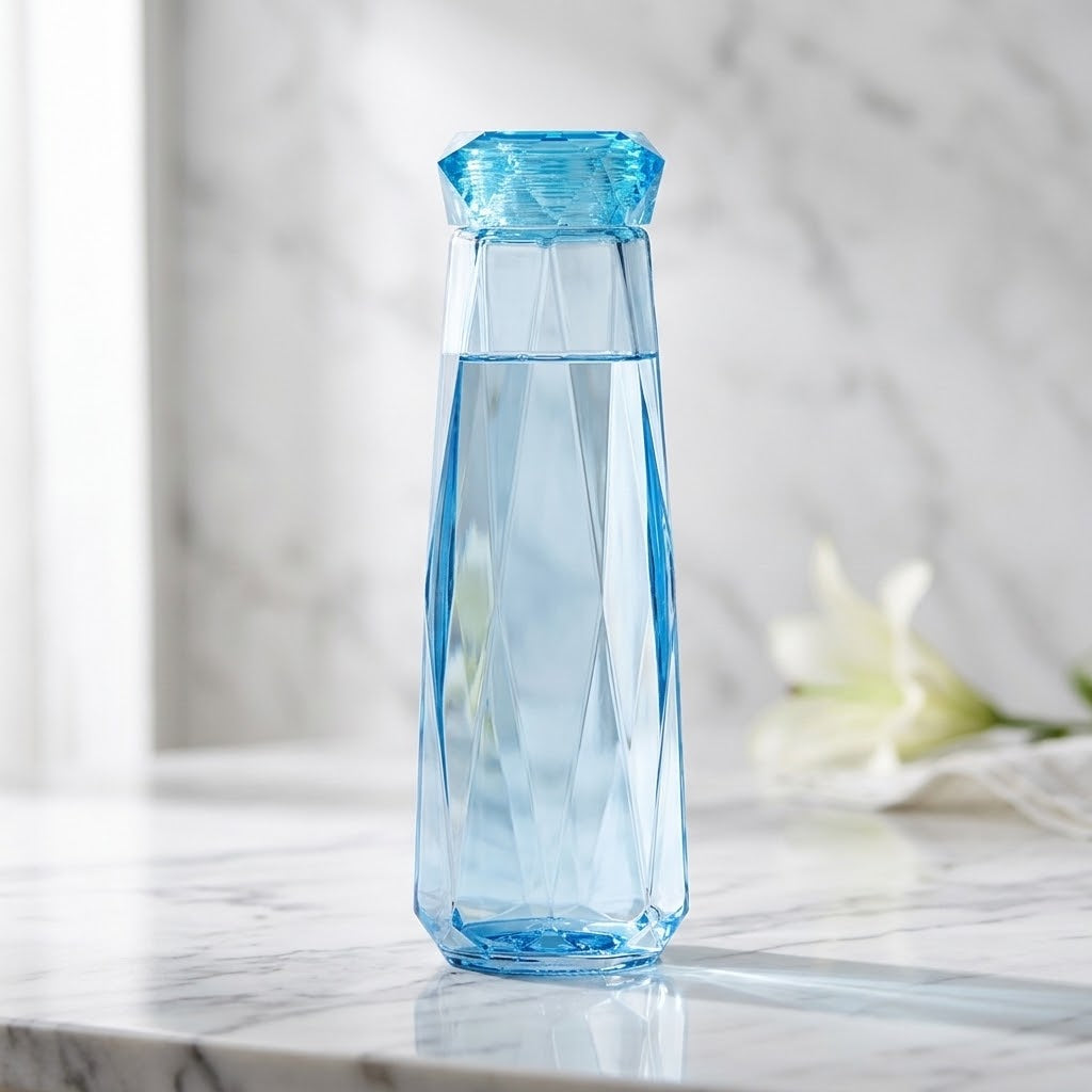 Colorful Glass Water Bottle with Lid on a marble countertop with a flower